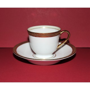 White cup and saucer with...